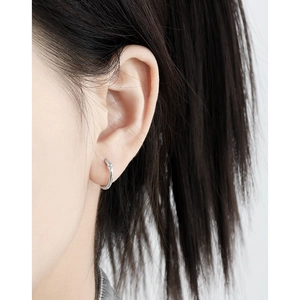 Minimalist S925 sterling silver hoop earrings with star design on a female model