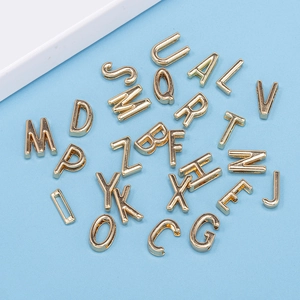 Golden 10mm alloy alphabet A-Z beads for DIY bracelets scattered on a blue background