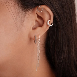 Close-up of S925 sterling silver tassel drop earrings and hoop stack on model ear