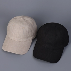 Close-up of linen texture on beige and black minimalist baseball caps in six-panel style