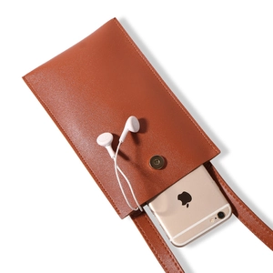 Minimalist tan leather crossbody phone bag with gold magnetic clasp and slim shoulder strap
