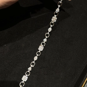 Detail of square zircon OT bracelet with various geometric crystals on black velvet tray