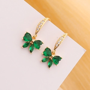 Golden butterfly earrings featuring emerald green teardrop stones and white zircon crystals
