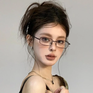 Vintage metal small frame anti-blue light glasses worn by model on a grey background