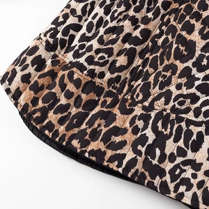 Detailed macro view of leopard print fabric with vertical quilting texture and stitching