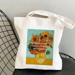 Van Gogh Sunflowers canvas tote bag with motivational quote on a metal chair