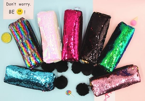 Macro view of colorful mermaid sequin pencil cases with soft pompom charms in 7 shades