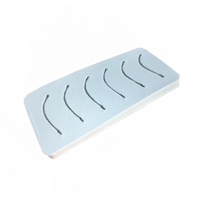 Macro view of white silicone suture practice pad with six pre-cut surgical wound shapes