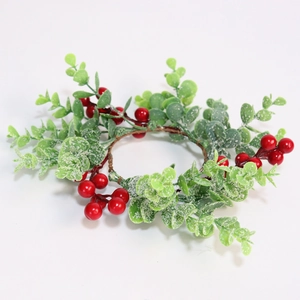 Close-up of artificial eucalyptus leaves with red berries and frosted snow effect
