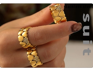Detail of vintage heart rings in 18K gold plated stainless steel with small crystals