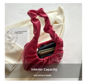 Detail of rose red ruched bag interior showing storage capacity for phone and wallet