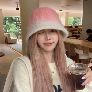Close-up of soft pink and white gradient faux fur material on a winter bucket hat