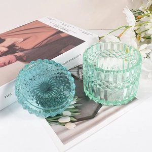 Embossed glass storage jar with striped carousel design in green and blue colors