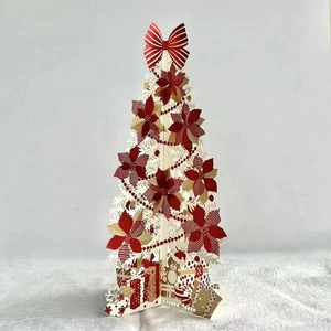 Creative 3D pop-up Christmas card featuring a red tree with gold foil and poinsettia decorations