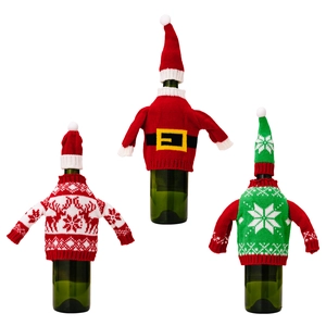 Three festive Christmas knit wine bottle sweaters with hats on a clean white background