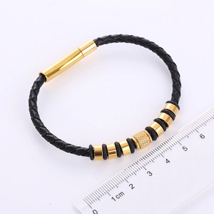 Detail shot of black braided leather bracelet for men with golden magnetic clasp and ruler