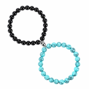 Detail of couple magnetic stone bracelets with lava rock and turquoise beads set