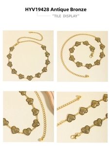 Detail of vintage bronze chain belt featuring embossed heart-shaped metal pieces and lobster clasp