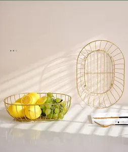 Detail of golden iron fruit basket with Nordic design and light luxury metallic texture