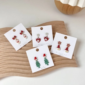 Christmas enamel earrings set featuring Santa Claus, reindeer, and snowman on display card