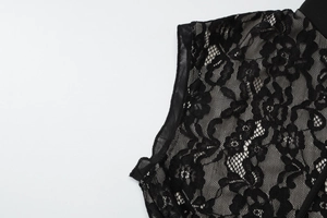 Close-up of black lace floral embroidery and sheer mesh detail on sleeveless dress