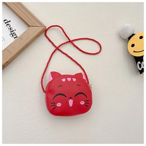 Detail of red cartoon cat child crossbody bag with woven rope strap on a minimal background