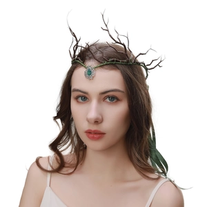 Detail of forest style branch headband with green gemstone pendant on female model
