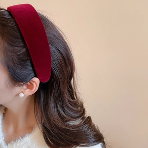 Detail of dark red velvet padded headband showcasing plush texture and retro elegant style