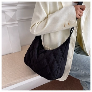 Close-up of quilted nylon hobo bag in black finish showing fabric texture and drape