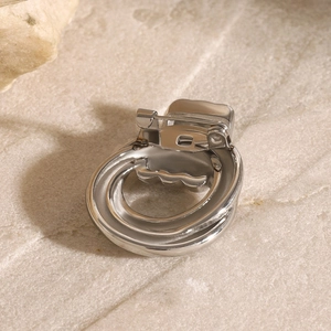 Close-up of the silver geometric brooch back showing the secure pin and safety clasp