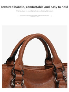 Detail view of brown textured leather handles with sturdy metal rings on a tote bag