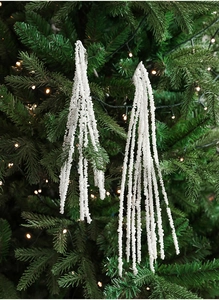 Close-up of white pearl bead branches on Christmas tree with warm festive lighting