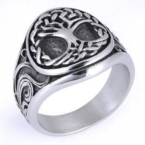 Detailed view of vintage tree of life engraving on a silver stainless steel ring band