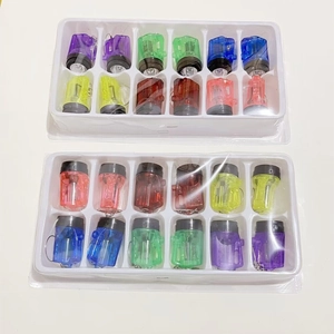 Bulk set of 24 colorful mini LED flashlight keychains in transparent plastic packaging