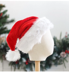 Close-up of red plush Santa hat with white faux fur trim on a mannequin head