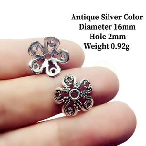 Macro detail of 16mm vintage silver alloy petal bead cap with embossed floral textures