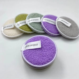 Macro detail of reusable microfiber face puffs with clean sponge logo strap in various colors
