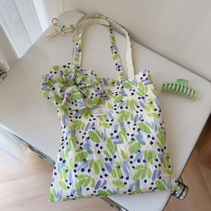 Detailed top view of natural pleated cotton tote bag and matching scrunchie with leaf print