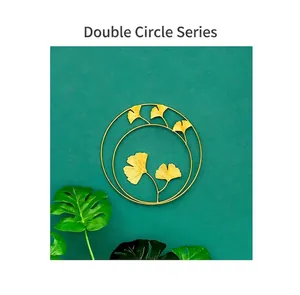 Modern luxury golden double circle wall art featuring delicate metal ginkgo leaves design