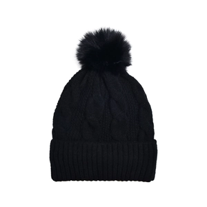 Detail of cable knit pattern and faux fur pompom on black winter beanie hat