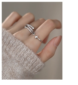 Detail of S925 silver star rings with zircon stones worn by a model on hand