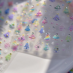 Detail of 3D Christmas tree nail stickers with sparkling rhinestones and snow motifs