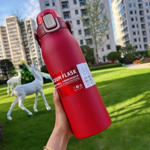 Close-up of red matte stainless steel vacuum insulated bottle with a transparent lid