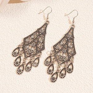 Vintage silver hollow flower drop earrings with bohemian tassel design for women