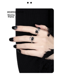 Close-up of irregular S925 silver ring with black onyx inlay on a model hand