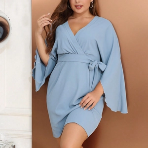 Detail of light blue V-neck dress featuring a wrap waist tie and elegant split flare sleeves