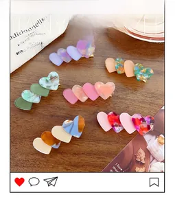 Detail of acetate heart hair clips with marble, tortoiseshell and gradient patterns