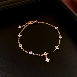 Detailed close-up of 18K gold plated zircon flower bracelet on premium black leather