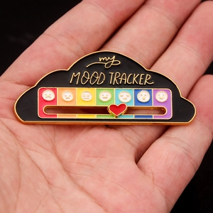 Close-up of the adjustable slider on the rainbow mood tracker enamel pin in hand