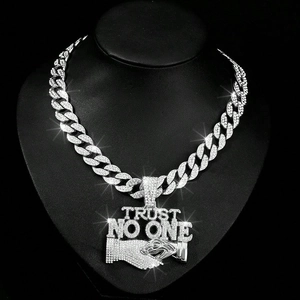 Close-up of Trust No One handshake pendant with silver Cuban chain and rhinestones